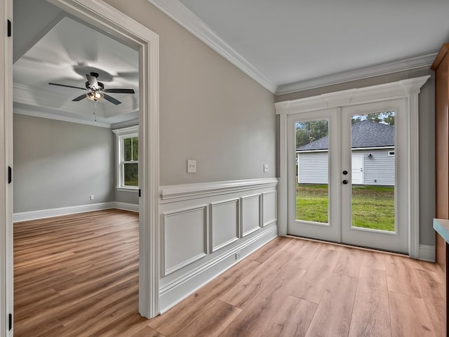 unfurnished room with ceiling fan, ornamental molding, light hardwood / wood-style floors, and french doors