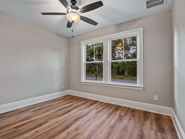 spare room with ceiling fan and light wood-type flooring