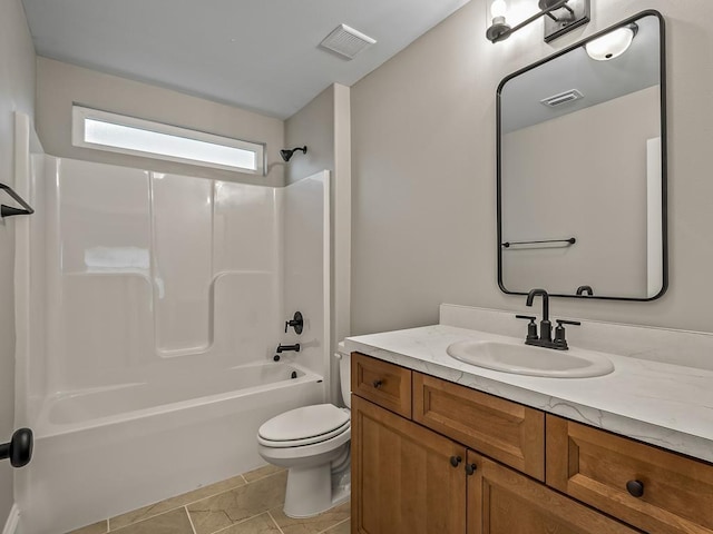 full bathroom featuring toilet, tile patterned floors, vanity, and  shower combination