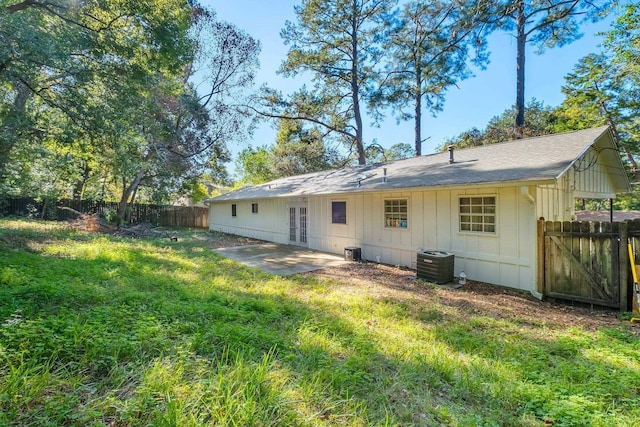 back of house featuring a yard, cooling unit, and a patio