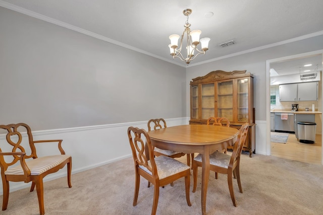 dining space with crown molding, light colored carpet, and an inviting chandelier