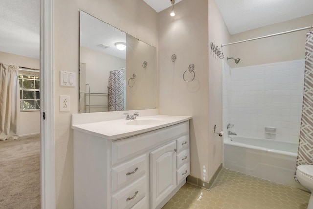 full bathroom featuring tile patterned floors, a textured ceiling, toilet, vanity, and shower / tub combo