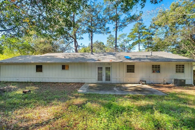 rear view of property with french doors, cooling unit, and a patio area