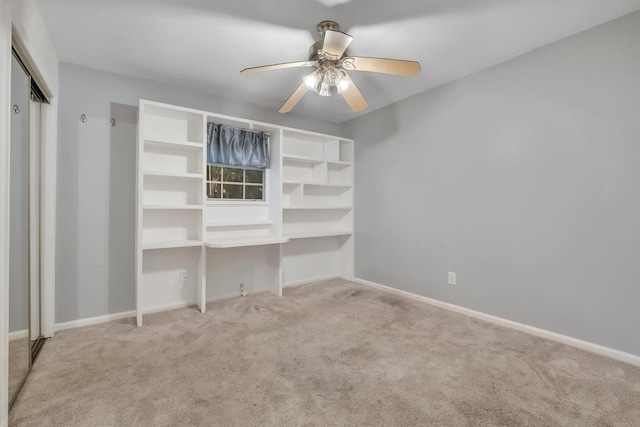 unfurnished bedroom with ceiling fan and light colored carpet