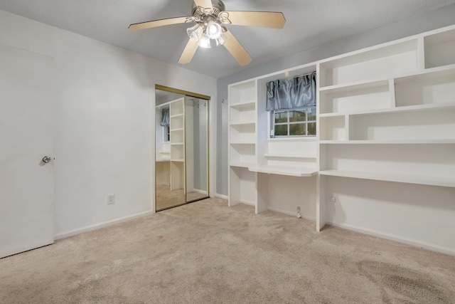 unfurnished bedroom with ceiling fan, light colored carpet, and a closet