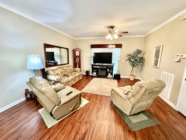 living room with hardwood / wood-style flooring, crown molding, and ceiling fan