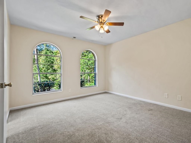 carpeted empty room with ceiling fan