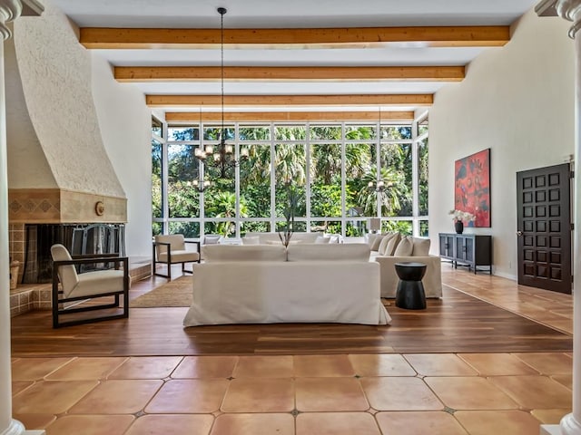 living room featuring beam ceiling, hardwood / wood-style flooring, and a notable chandelier