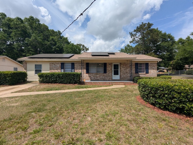 1106 Woodland Dr, Tallahassee, FL 32305 - single story home with a front yard, solar panels, covered porch, and brick siding