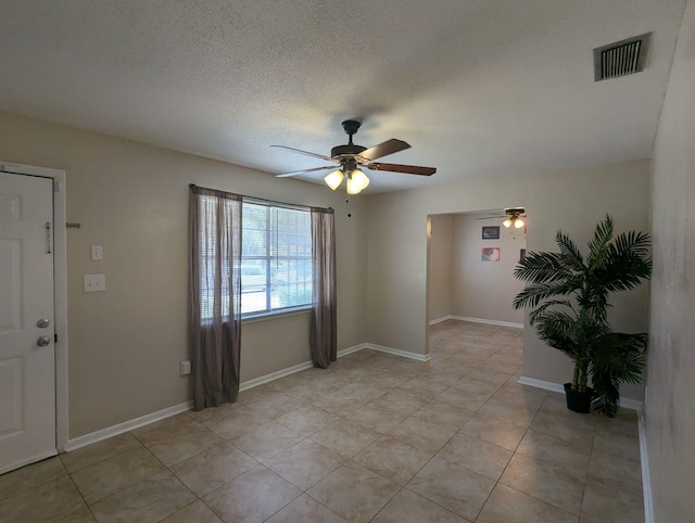 1106 Woodland Dr, Tallahassee, FL 32305 - empty room with light tile patterned floors, ceiling fan, visible vents, and a textured ceiling