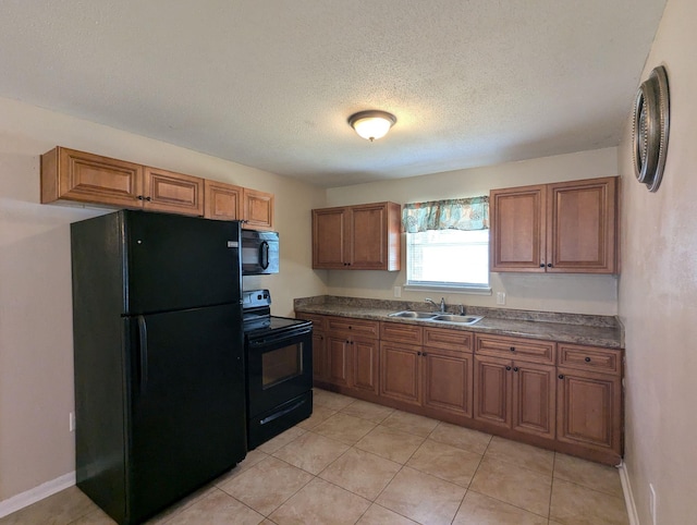 1106 Woodland Dr, Tallahassee, FL 32305 - kitchen featuring black appliances, a sink, and brown cabinetry