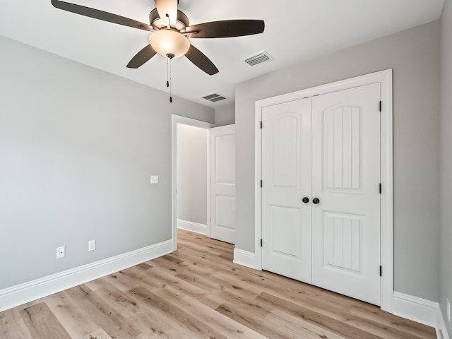 unfurnished bedroom featuring a closet, light hardwood / wood-style floors, and ceiling fan