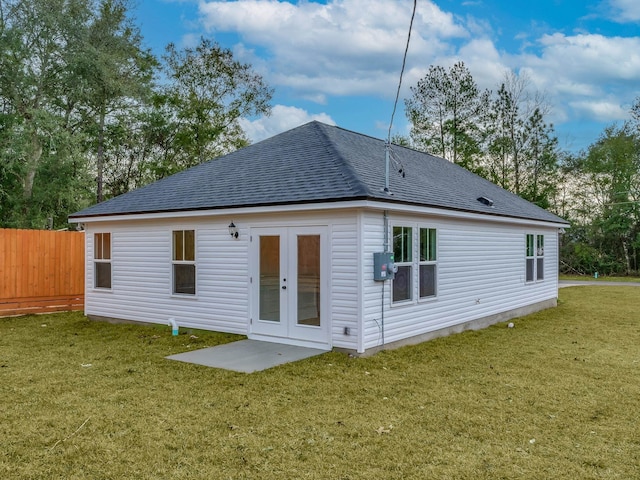 rear view of property featuring a yard and french doors