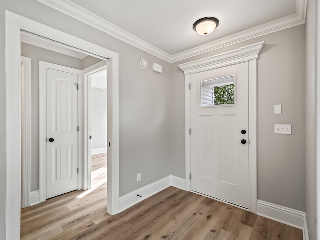 entrance foyer featuring crown molding and light wood-type flooring