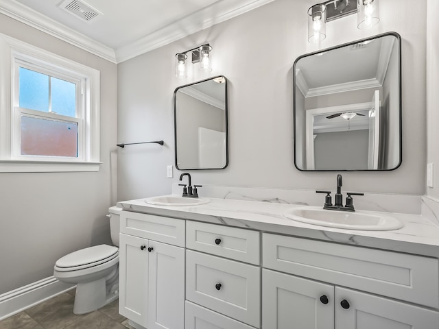 bathroom with toilet, vanity, and ornamental molding