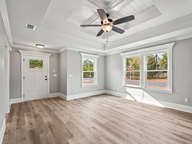 foyer featuring a tray ceiling, light hardwood / wood-style flooring, a wealth of natural light, and crown molding