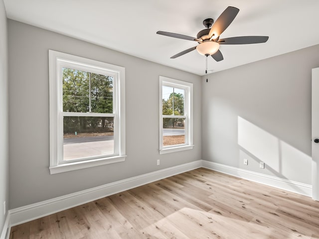 empty room with light hardwood / wood-style flooring and ceiling fan