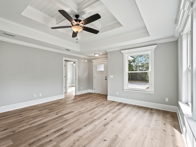 interior space featuring ceiling fan, light hardwood / wood-style floors, ornamental molding, and a tray ceiling