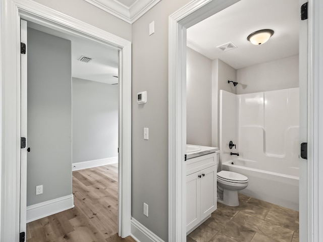 full bathroom featuring ornamental molding, vanity,  shower combination, hardwood / wood-style floors, and toilet