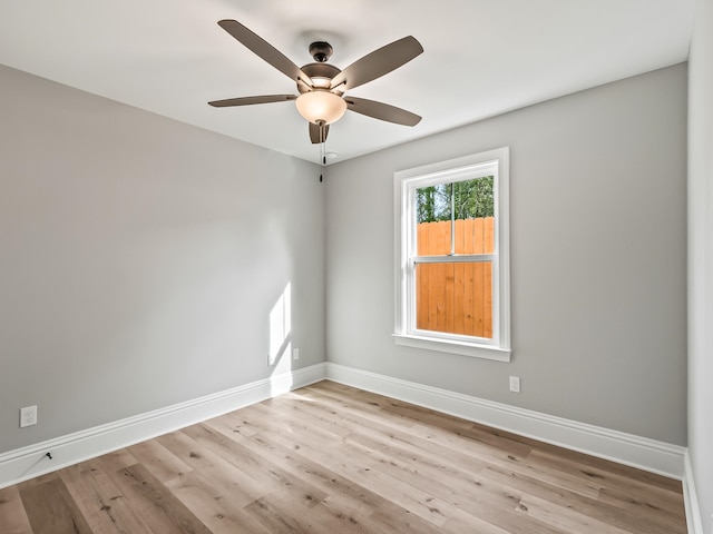 spare room featuring light wood-type flooring and ceiling fan