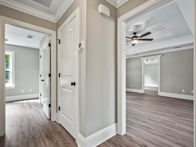 hallway featuring wood-type flooring and ornamental molding