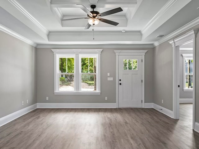 foyer entrance with dark hardwood / wood-style flooring, ceiling fan, a raised ceiling, and crown molding