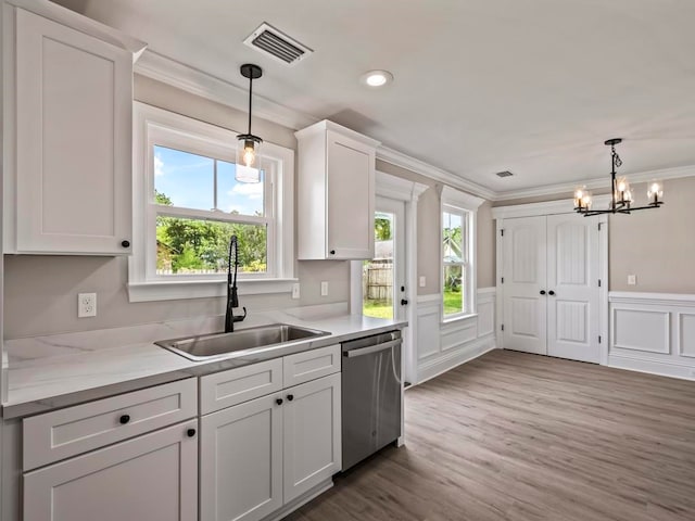 kitchen featuring crown molding, sink, white cabinets, and stainless steel dishwasher