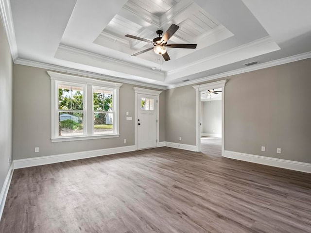 unfurnished room with dark wood-type flooring, crown molding, and a tray ceiling