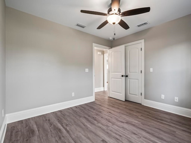 unfurnished bedroom featuring hardwood / wood-style flooring and ceiling fan