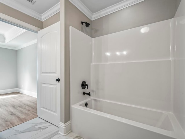 bathroom with washtub / shower combination and crown molding