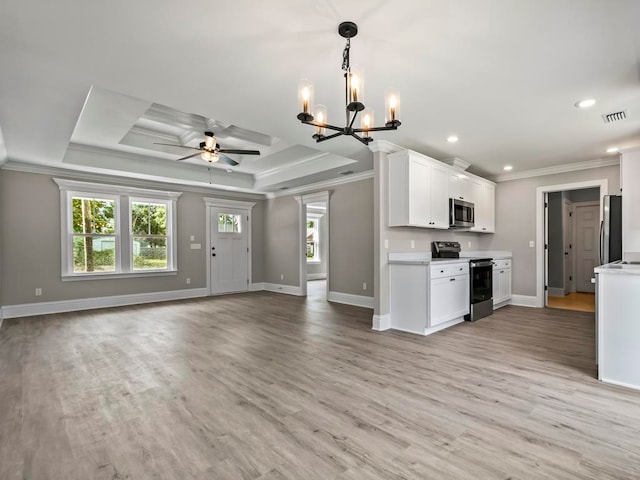 kitchen featuring a raised ceiling, white cabinetry, light hardwood / wood-style flooring, and appliances with stainless steel finishes