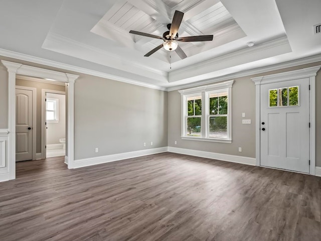 interior space with a tray ceiling and a healthy amount of sunlight