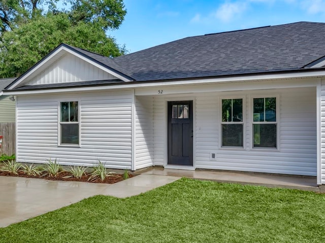 view of front of property with a porch and a front lawn