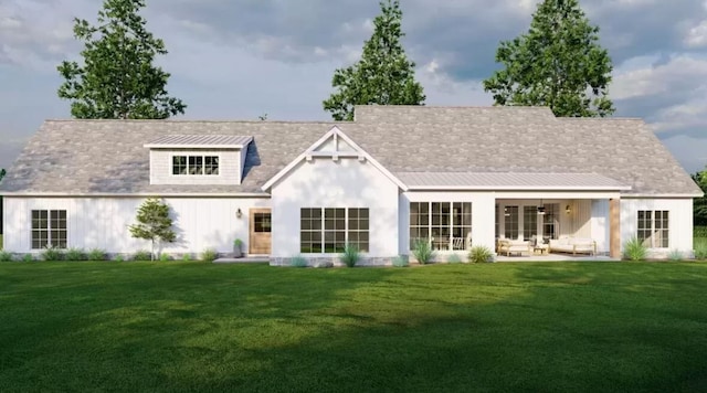 rear view of house with a patio and a lawn