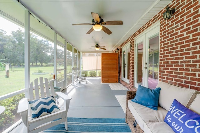 sunroom featuring ceiling fan and plenty of natural light