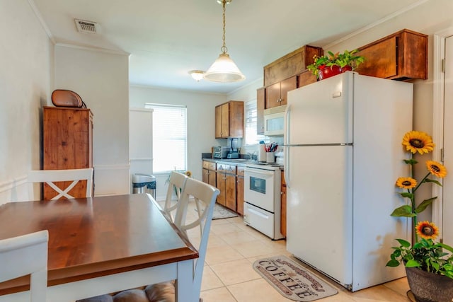 kitchen featuring hanging light fixtures, light tile patterned floors, sink, crown molding, and white appliances