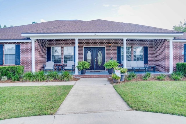 view of front of house with french doors and a front lawn