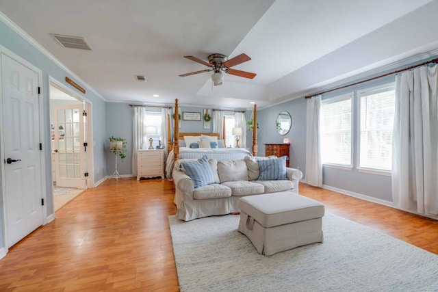 bedroom with ornamental molding, ensuite bath, light wood-type flooring, vaulted ceiling, and ceiling fan