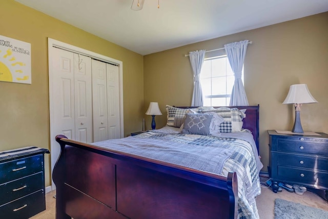 bedroom featuring light colored carpet and a closet