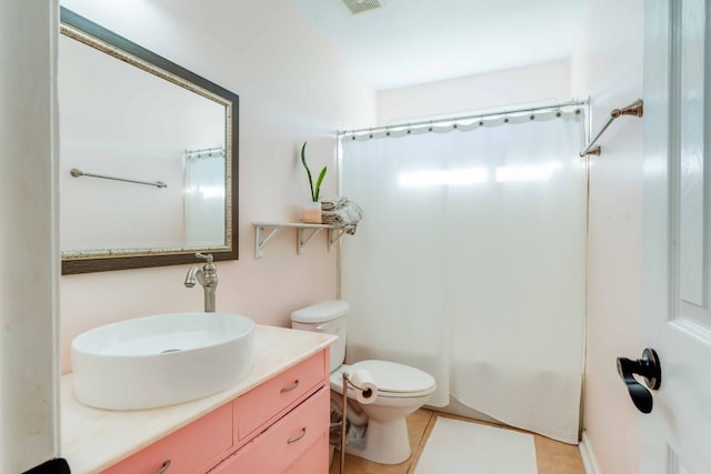 full bathroom featuring toilet, shower / tub combo, vanity, and tile patterned flooring