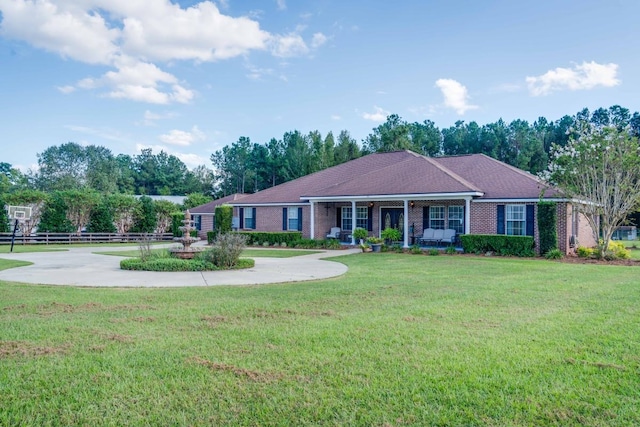 single story home with a front yard and covered porch