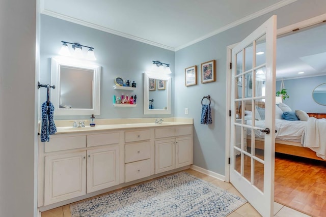 bathroom with tile patterned flooring, vanity, and crown molding