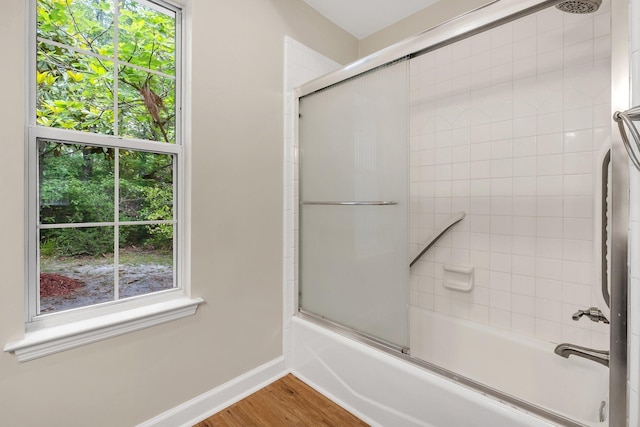 32 Pirates Cove Ln, Saint Marks, FL 32355 - full bath with shower / bath combination with glass door, plenty of natural light, baseboards, and wood finished floors
