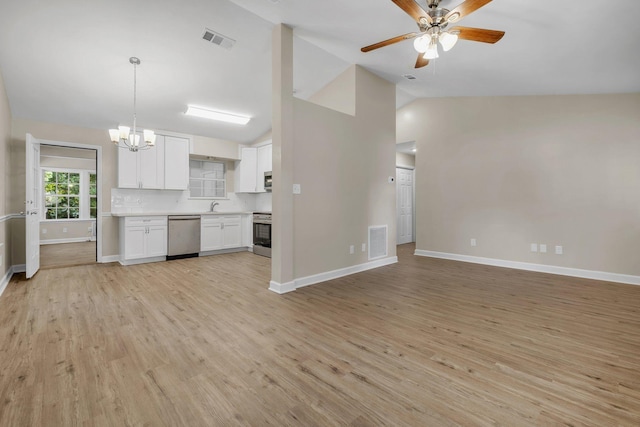 32 Pirates Cove Ln, Saint Marks, FL 32355 - unfurnished living room featuring a chandelier, a ceiling fan, light wood-type flooring, baseboards, and high vaulted ceiling