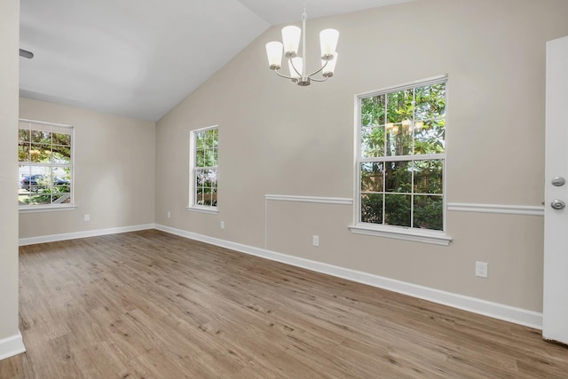 32 Pirates Cove Ln, Saint Marks, FL 32355 - unfurnished room featuring a chandelier, wood finished floors, lofted ceiling, and baseboards