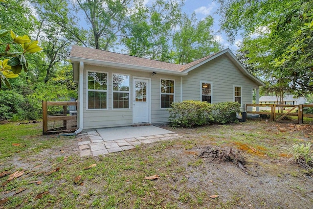 32 Pirates Cove Ln, Saint Marks, FL 32355 - rear view of house with a shingled roof, a patio area, and fence