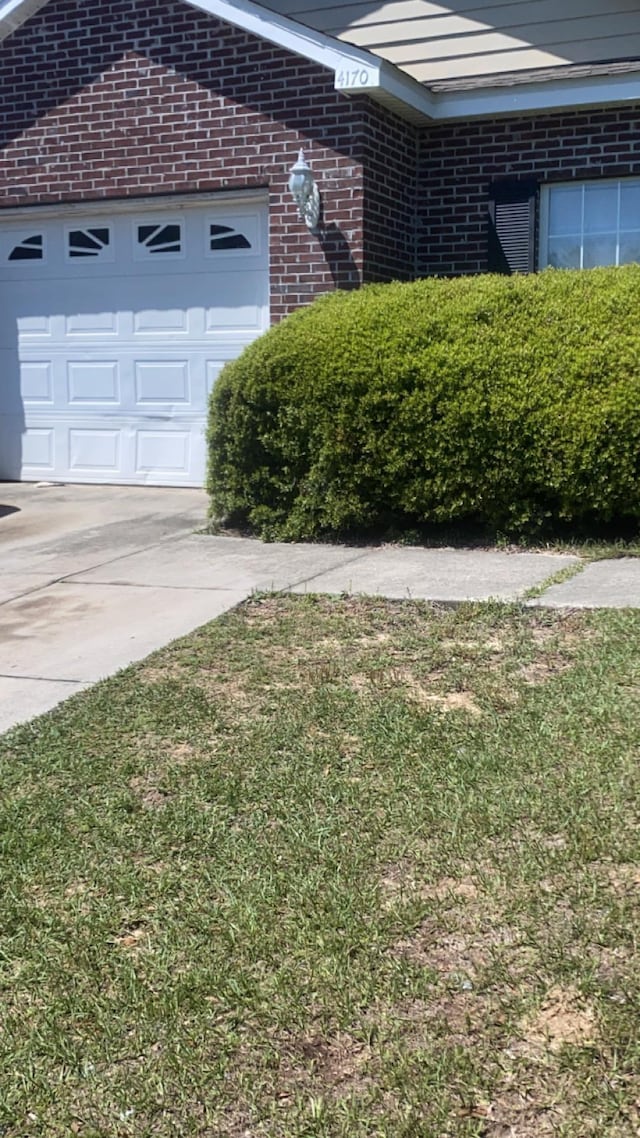 4170 Ridge Haven Rd, Tallahassee, FL 32305 - view of home's exterior with a garage, brick siding, and driveway