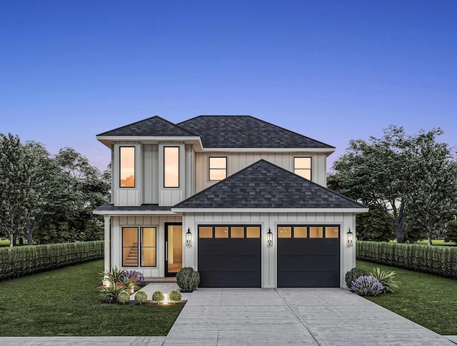 view of front of home featuring a garage and a lawn