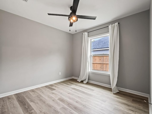 spare room featuring ceiling fan and light hardwood / wood-style floors