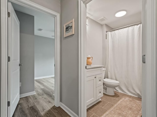 bathroom featuring hardwood / wood-style floors, vanity, and toilet